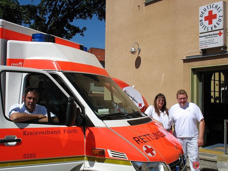 Bild 1 von 1 Der Rettungswagen 52/93 in Stein. Hier mit einer Rettungsassistentin des BRK Fürth zwei Kameraden der FF Roßtal.